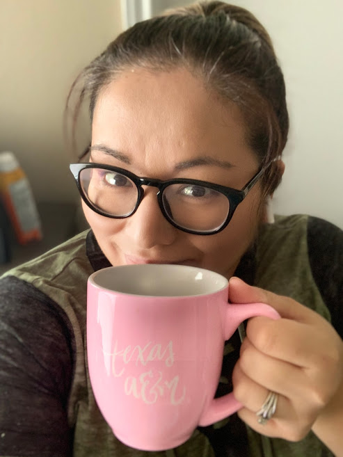 Jessica smiling behind a cup of coffee | Coastal Bend Mom Collective