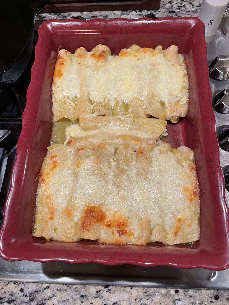 Baking Dish with Cooked Green Chili Enchiladas