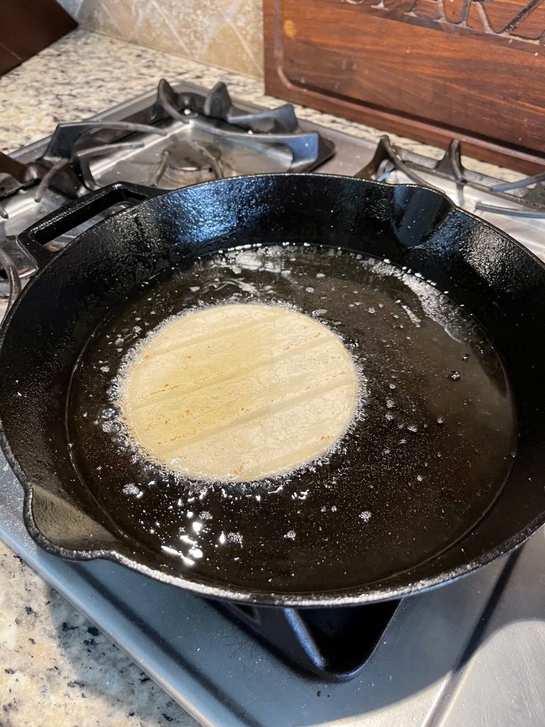 Image of Cast Iron Skillet with a tortilla heating in oil