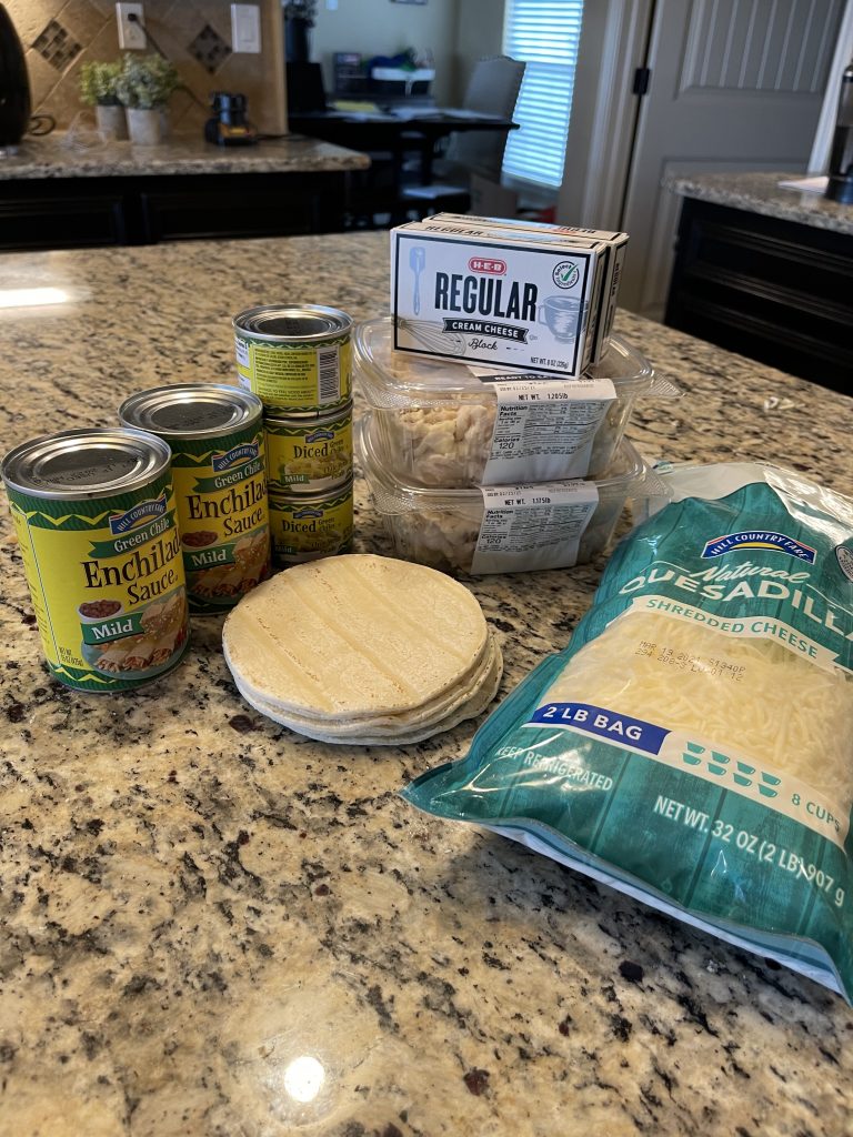 Picture of Ingredients for Enchiladas: Enchilada sauce, tortillas, shredded chicken, cream cheese, large bag of shredded cheese