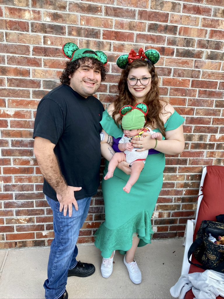 EJ, Maria, and baby Wesley Perez - all three wearing green sequined Mickey Mouse Ears.