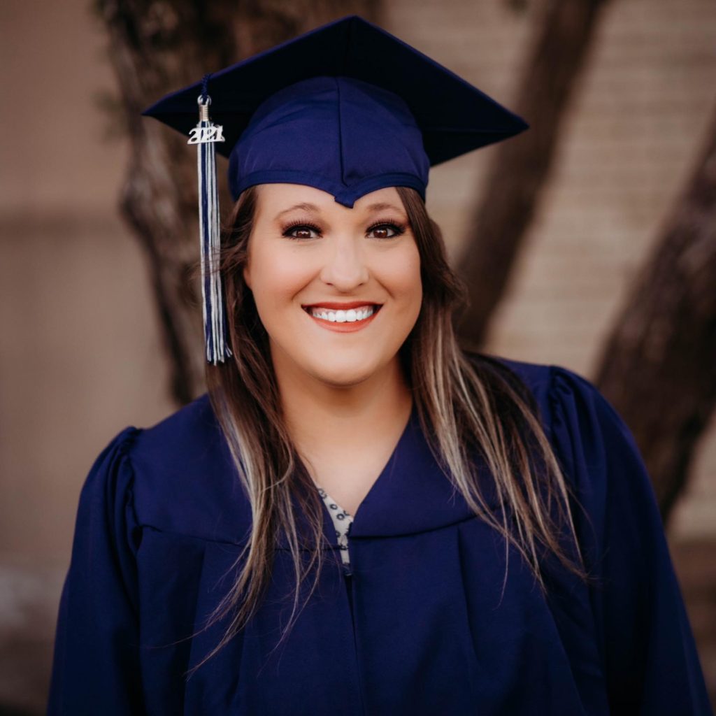 Woman with brown hair and brown eyes in Blue Graduation Cap and Gown 