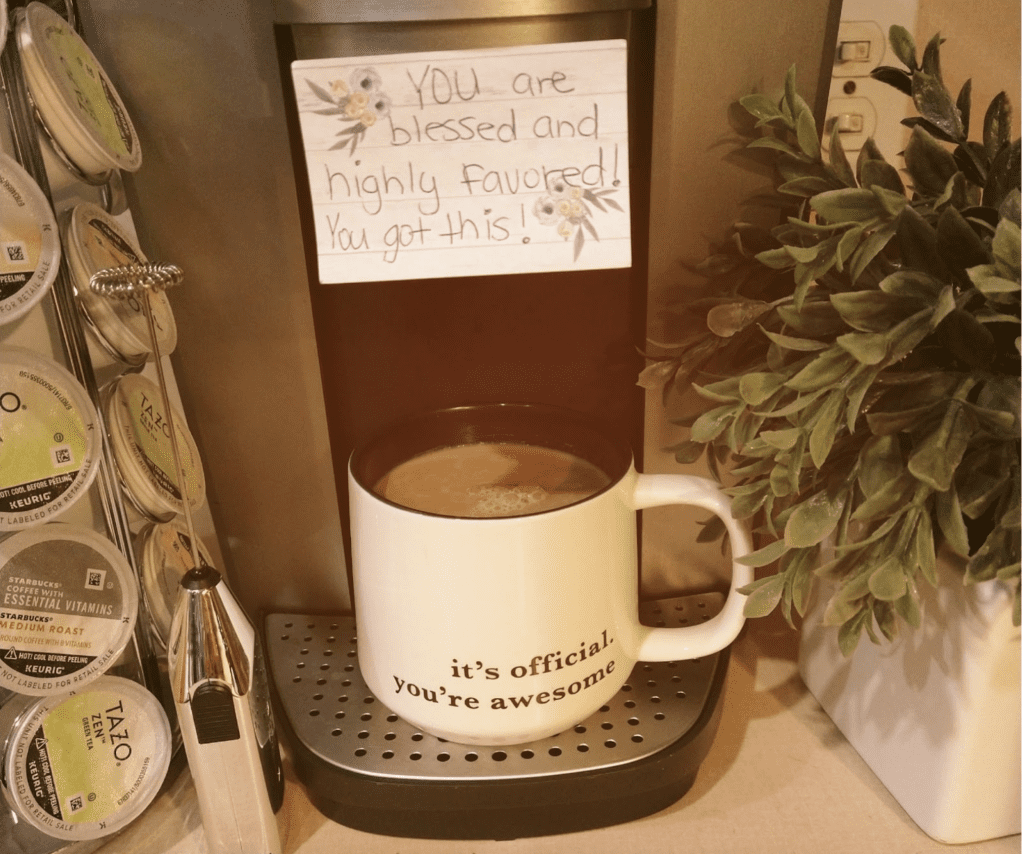 Image of a Coffee Cup that says "it's official, you're awesome" and a post it note stuck to the coffee pot that reads: "You are blessed and highly favored! You got this!"