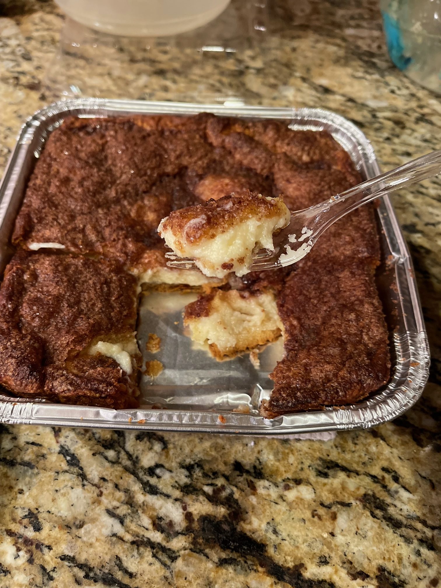 sopapilla pie cooked with a fork holding a bite ready to eat