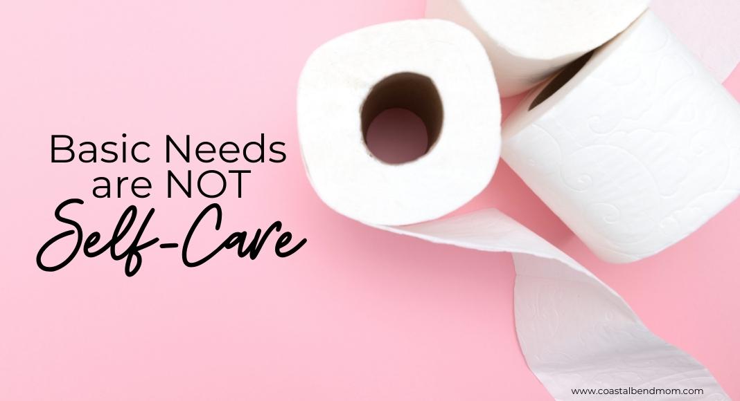 Text reads: Basic Needs are NOT self-care. Background is pink, with three rolls of white toilet paper.