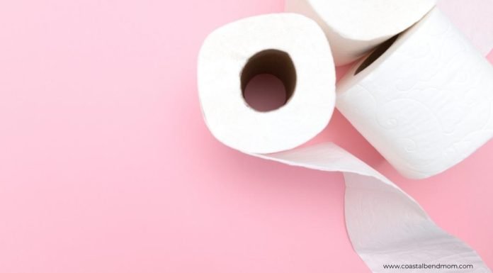 Image of three rolls of white toilet paper with a pink background.