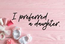 Image reads "I preferred a daughter." Pink background with pink accented baby toy and white baby shoes with pink bows.