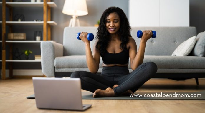 Woman doing a home workout with laptop