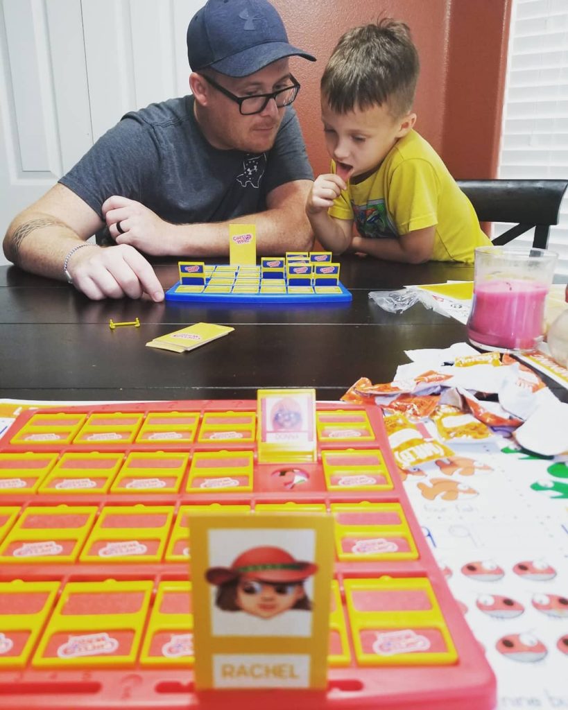 Dad and Son playing Guess Who 