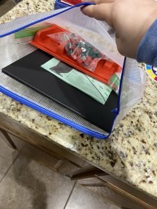 Showing that the plastic tray from Monopoly fits inside the bag 