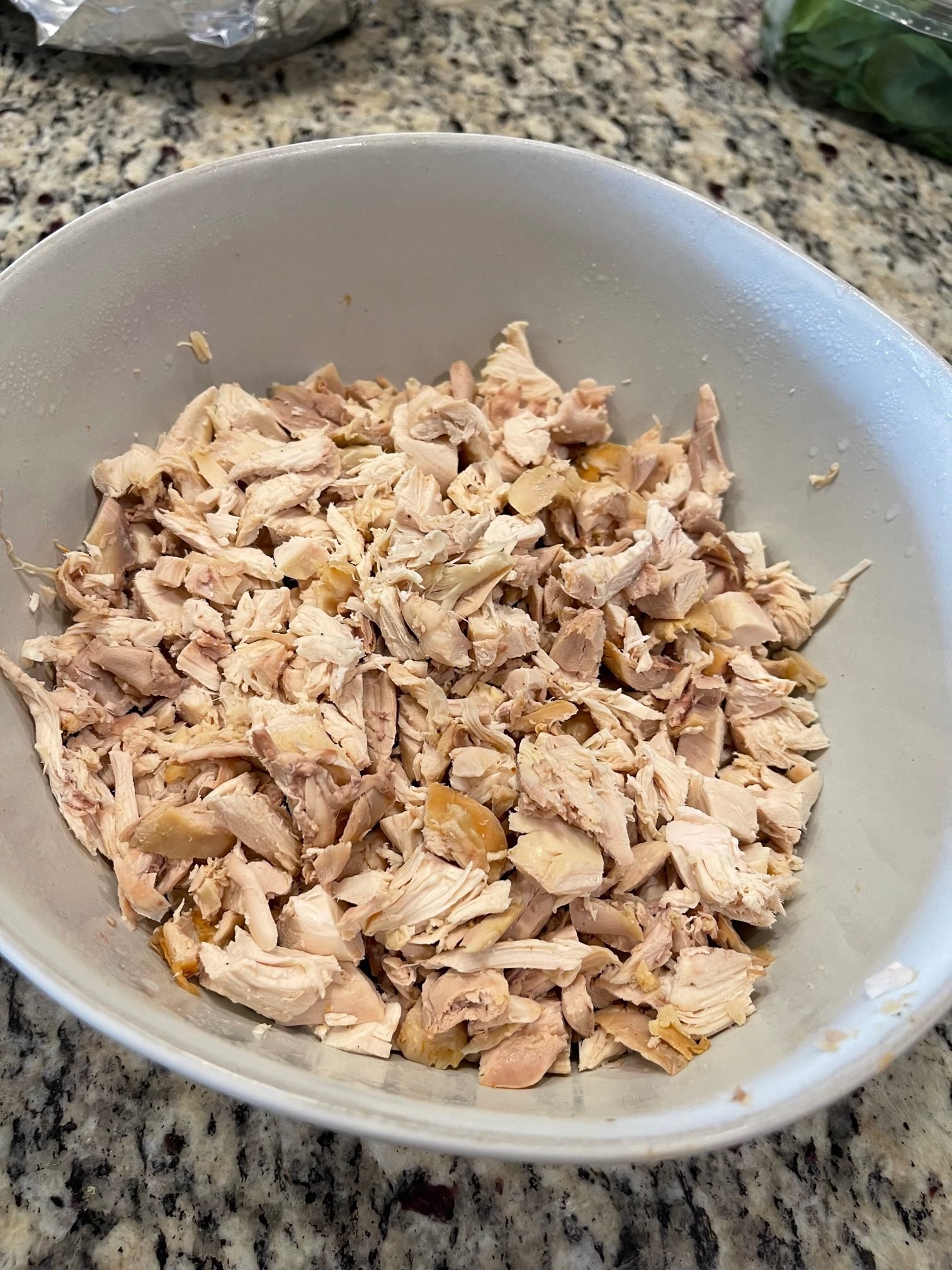 Large bowl of chopped and cooked chicken