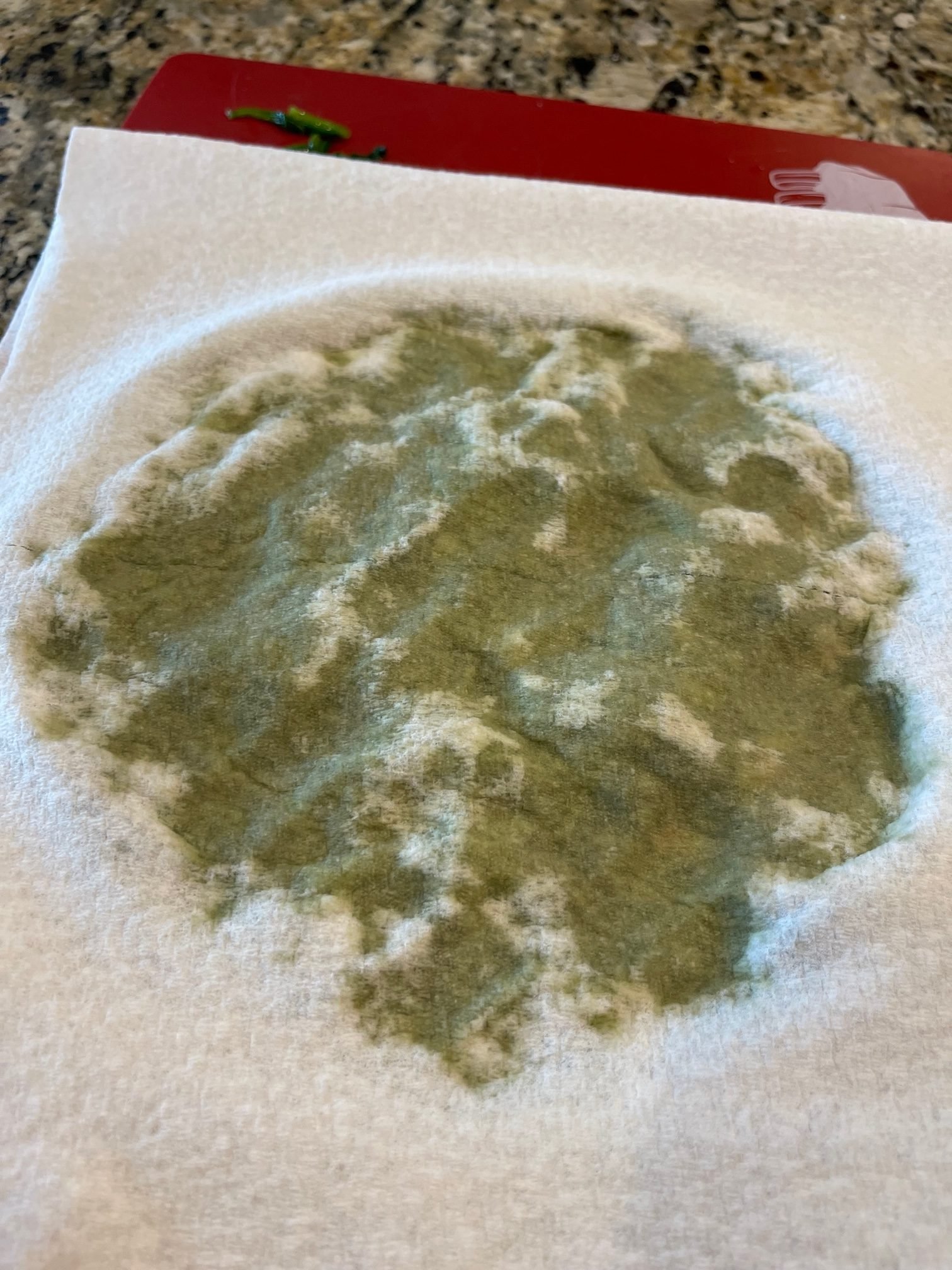 Use a paper towel to soak up the excess liquid from the cooked spinach